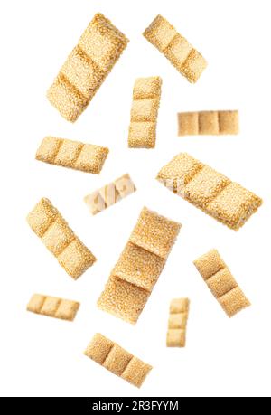 Delicious sesame kozinaki bars falling on white background Stock Photo