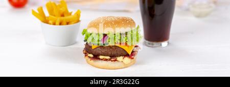 Hamburger cheeseburger fast food meal menu with fries and coke drink on wooden board panorama Stock Photo