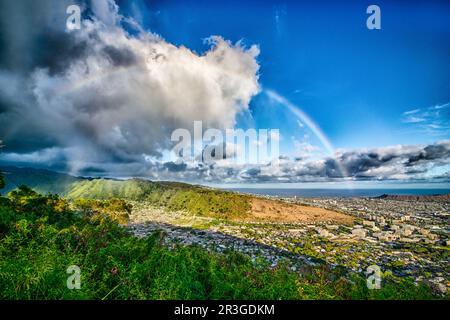 Rainbow over honolulu hawaii after rain Stock Photo