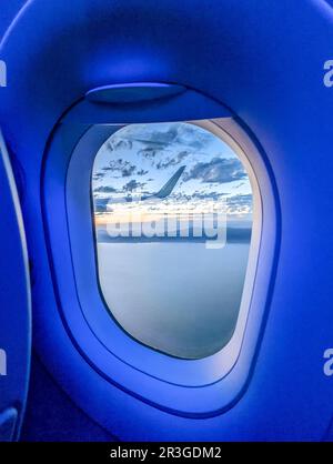 Clouds and sky as seen through window of an aircraft Stock Photo