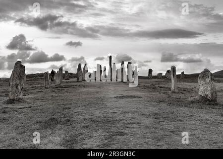 Callanish Stones Megalithic Formation, Standing Stones of Callanish, Stone Circle with Visitors, Cloudy Sky, Isle of Lewis and Harris, Outer Stock Photo