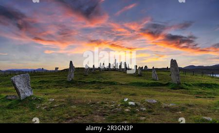 Callanish stones megalithic formation, stone circle with visitors, sunset, Isle of Lewis and Harris, Outer Hebrides, Scotland, United Kingdom Stock Photo