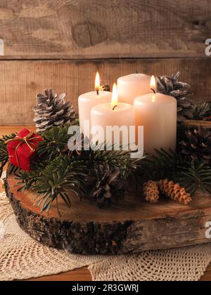 Third Advent, one rustic - Christmas Stock candle wooden Alamy with decoration on burning a Photo table