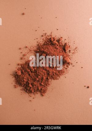 Chocolate powder on a brown background, top view, studio photography, healthy food, fair trade Stock Photo