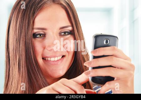 Smiling young woman using smartphone. Selfie Stock Photo