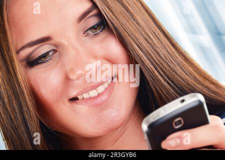 Smiling young woman using smartphone. Selfie Stock Photo
