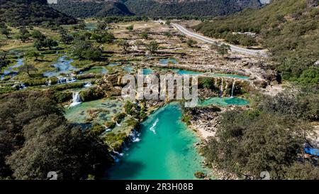 Aerial of turquoise waterfalls, Wadi Darbat, Salalah, Oman Stock Photo