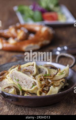 Swabian Maultasche with onions in the pan Stock Photo