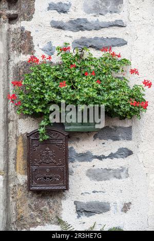 Old rusty letterbox on an old stone wall Stock Photo