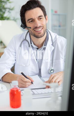 portrait of positive male caucasian doctor in white uniform Stock Photo