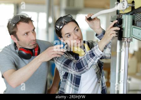man and woman with machine cnc Stock Photo