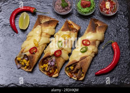 Baked enchiladas with salsa Stock Photo