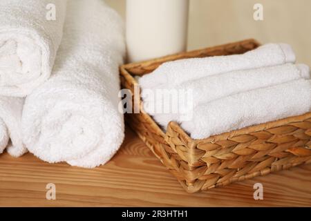 Soft folded terry towels on wooden table, closeup Stock Photo