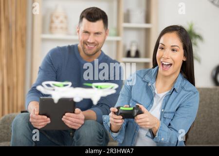 happy couple using modern drone Stock Photo
