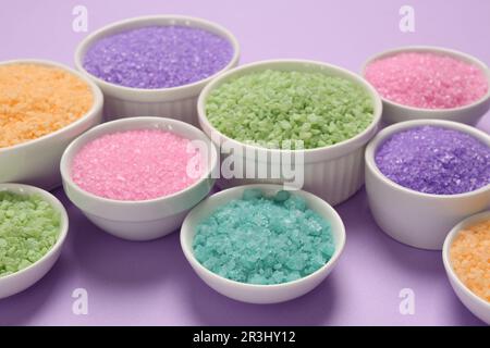 Different types of aromatic sea salt on purple background Stock Photo ...