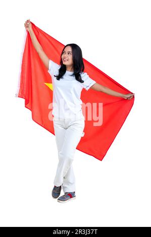 Asian women celebrate Vietnam independence day on 02 September by holding the Vietnam flag isolated over white background Stock Photo