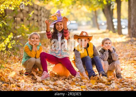 Kids picking and carving pumpkins at country farm Stock Photo