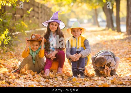 Group of little kids enjoying harvest festival celebration at pumpkin fields Stock Photo