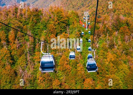 Cable car cabin rises up from Rosa Khutor village to Roza Peak mountain in Sochi resort city in Krasnodar Krai, Russia Stock Photo