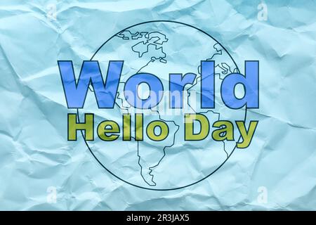 Phrase World Hello Day and image of Earth on crumpled light blue paper Stock Photo
