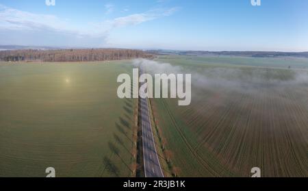 Country road with fog cloud from the air Stock Photo - Alamy