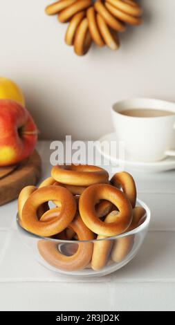 Bowl with delicious ring shaped Sushki (dry bagels) on white table Stock Photo
