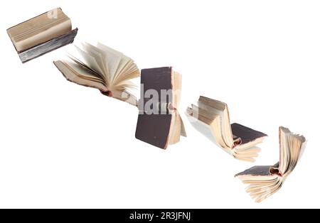 Many hardcover books flying on white background Stock Photo