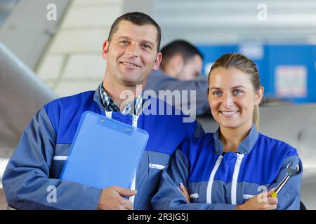 mechanics in hangar repairing light aircraft Stock Photo