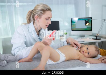 pediatrician is taking care of baby in hospital Stock Photo