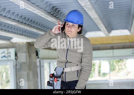 woman builder on the phone Stock Photo