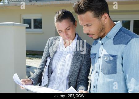 man and woman engineers work on plans construction Stock Photo