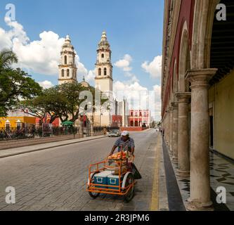 Man pushing cart in main square of Campeche city, Campeche State, Mexico Stock Photo