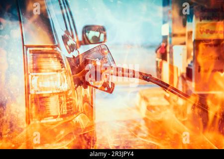 pumping gasoline fuel in a car at a gas station. Fire effect. Stock Photo