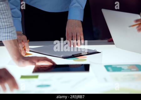 Project manager discussing new strategy of company with team, working on startup product over modern office interior design Stock Photo