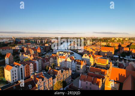 Beautiful architecture of old town in Gdansk, Poland at sunny day. Aerial view from drone of the Main Town Hall and St. Mary Bas Stock Photo