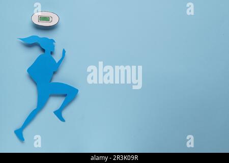 Woman's health. Female paper figure and battery symbol on light blue background, flat lay with space for text Stock Photo