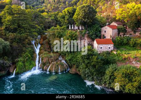 Krka, Croatia - Aerial view of the beautiful Krka Waterfalls in Krka National Park on a bright summer morning with traditional small houses Stock Photo