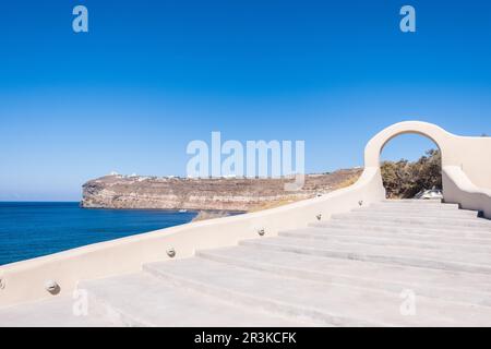 White stone staircase with blue beach and mountains of Santorini on the background Stock Photo