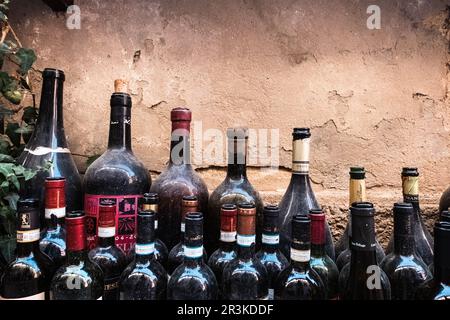 Old open red wine bottles dusted by time Stock Photo