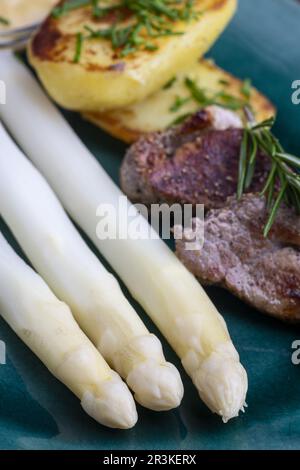 Grilled pork tenderloin with asparagus Stock Photo