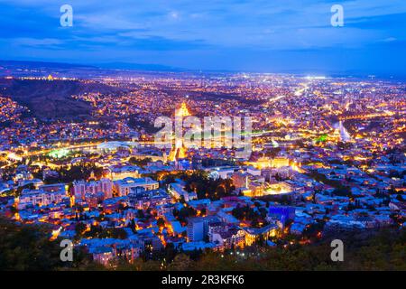 Tbilisi old town aerial panoramic view at night. Tbilisi is the capital and the largest city of Georgia, lying on the banks of the Kura River. Stock Photo