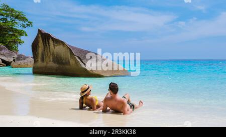 Men and women on the tropical white beach with turqouse colored ocean of Similan Islands Thailand Stock Photo