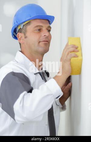 polishing plastered walls with sponge Stock Photo