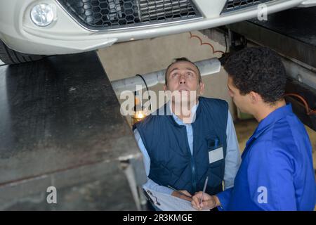 portrait of mechanic repairing a car Stock Photo