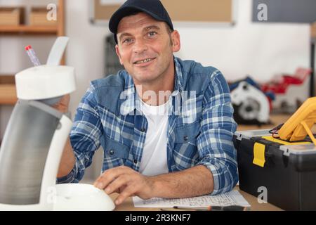 professional worker is fixing coffee machine Stock Photo