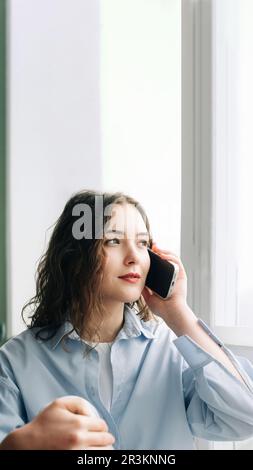 Caring wife by the window eagerly awaiting her husband's arrival