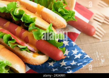 4th of July American Independence Day traditional picnic food. Hot dog with potato chips and cocktail, American flags and symbols of USA Patriotic pic Stock Photo