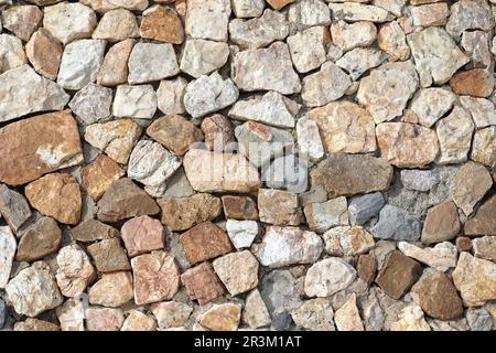 Granite stone wall, pattern of natural gray granite stone wall for background. Stock Photo