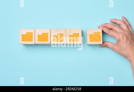 Cubes with folder icons on a blue background. Data systematization concept, paperless information exchange Stock Photo