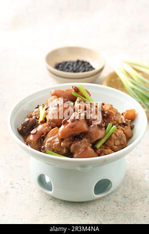 A delicious Chinese dish, braised pork feet(Pig Trotters) with black peanut Stock Photo